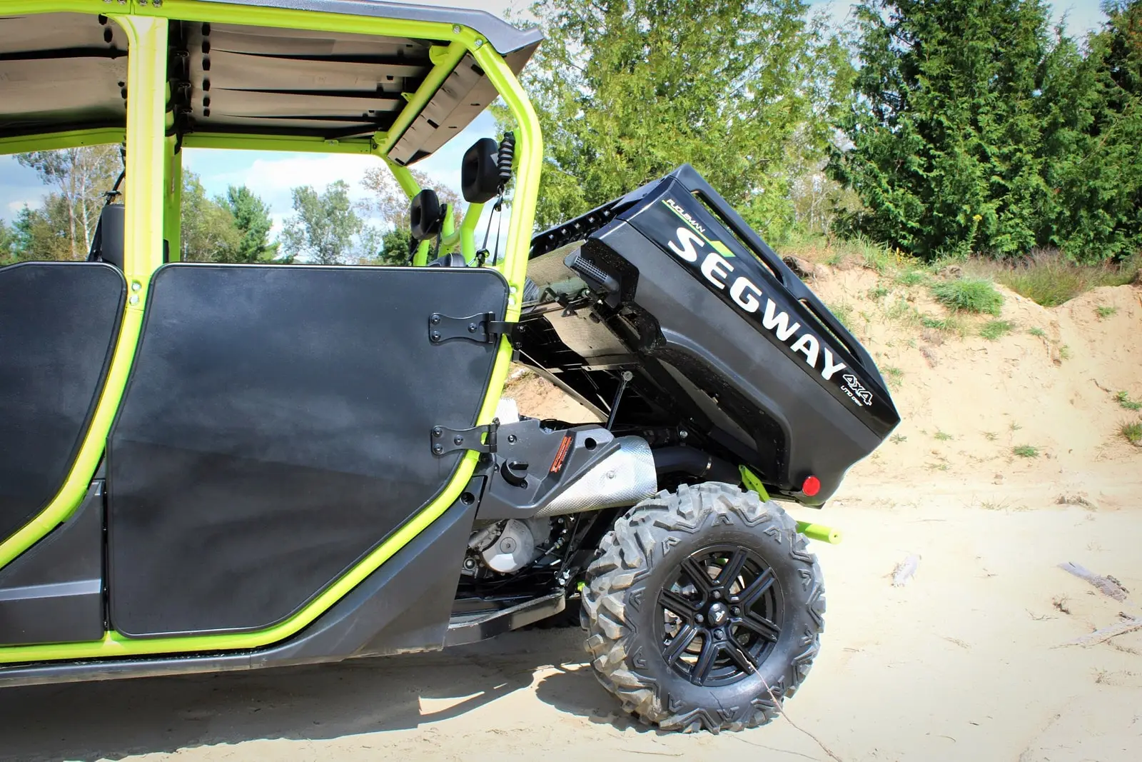 A Segway Fugleman UT10 Crew utility side-by-side with its rear cargo bed lifted, revealing the loading area.